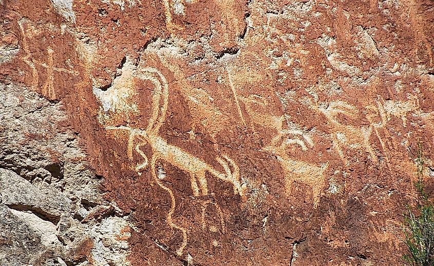 Fremont Indian-carved petroglyphs (~400 to ~1350 A.D.) on volcanic tuff cliff face (Joe Lott Tuff, Lower Miocene, 19 Ma) in Utah.