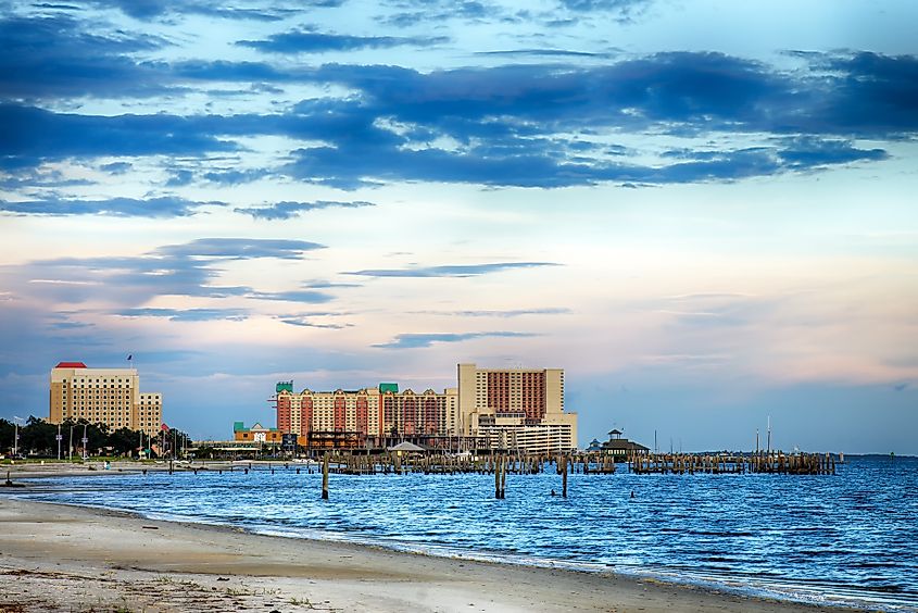 Biloxi, Mississippi: Casinos and buildings along the Gulf Coast shore at sunset.