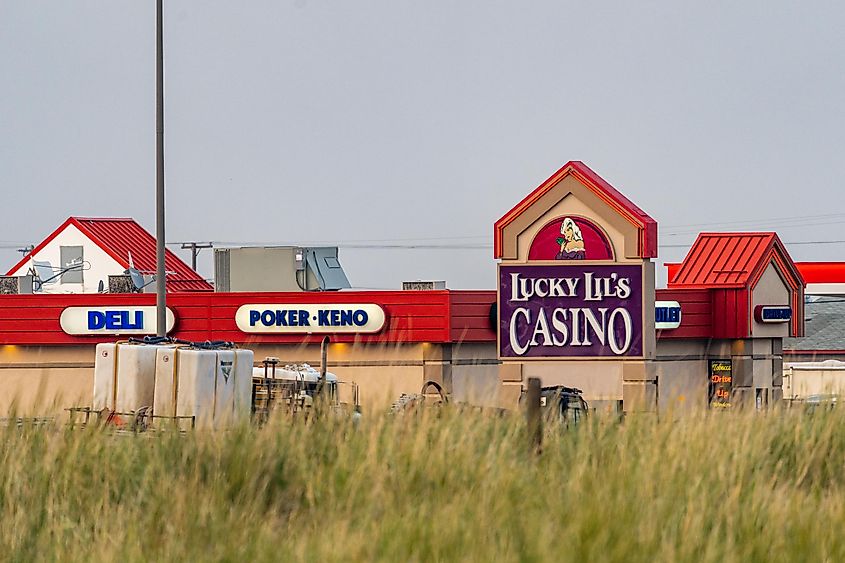 A Lucky Lils Casino sign at a Towne Pump Gas Station, via melissamn / Shutterstock.com