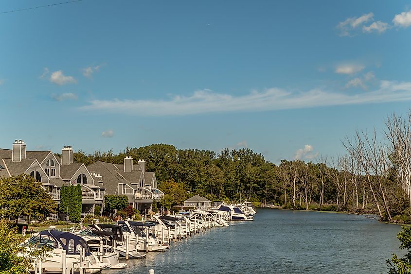  Boats in focus in front of beautiful townhome real estate in the lovely beach and harbor area.