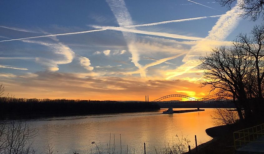 Barge on the Ohio River in Indiana at sunset.