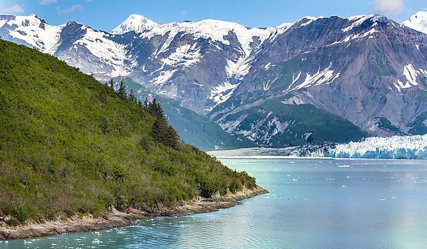 A scenic view of snow-capped mountains and water from a ship of the Glacier Bay National Park and Preserve
