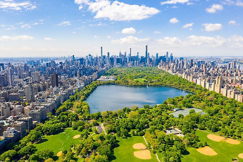 Aerial view of the Central park in New York with golf fields and tall skyscrapers surrounding the park