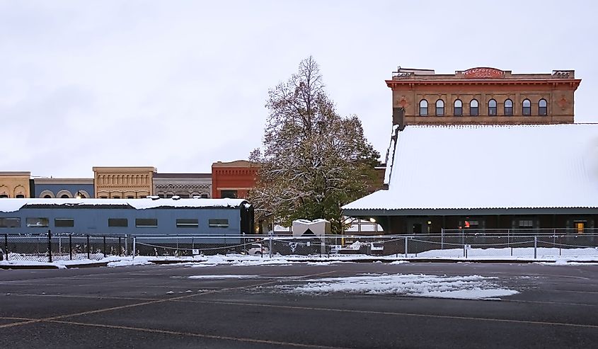 An old train station with colorful historic buildings behind it in Fargo, North Dakota
