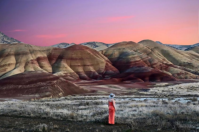 Vacation travel in Oregon. Woman enjoying the view of beautiful Painted Hills at sunset. John Day Fossil Beds National Monument Bend. Or. United States of America.