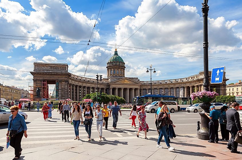 Pedestrians pass Nevsky Prospekt in summer sunny day near the Kazan cathedral