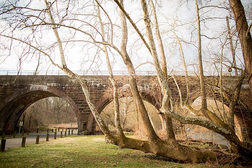 Landscape view of a old stone archway bridge located in Playwicki Park in Langhorne, Pennsylvania.