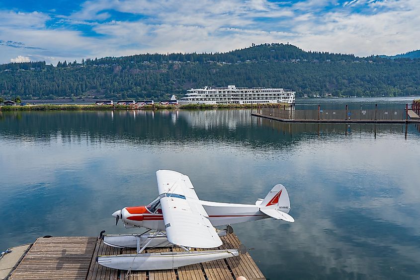 seaplane with a river cruise ship in the background in the Hood River Marina, Oregon.