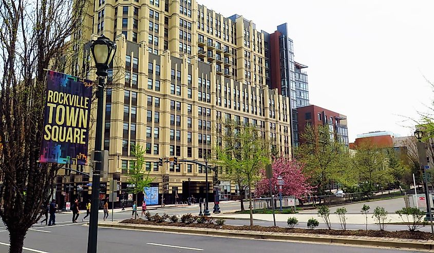 treet scene in downtown Rockville, MD with sign and buildings.