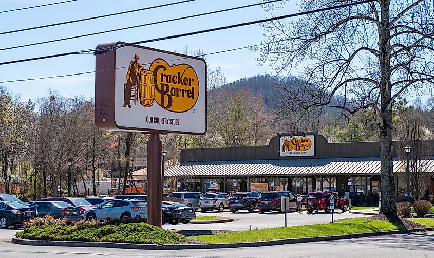 Cracker Barrel Old Country Store and sign and busy parking lot with cars and vehicles in Tennessee.