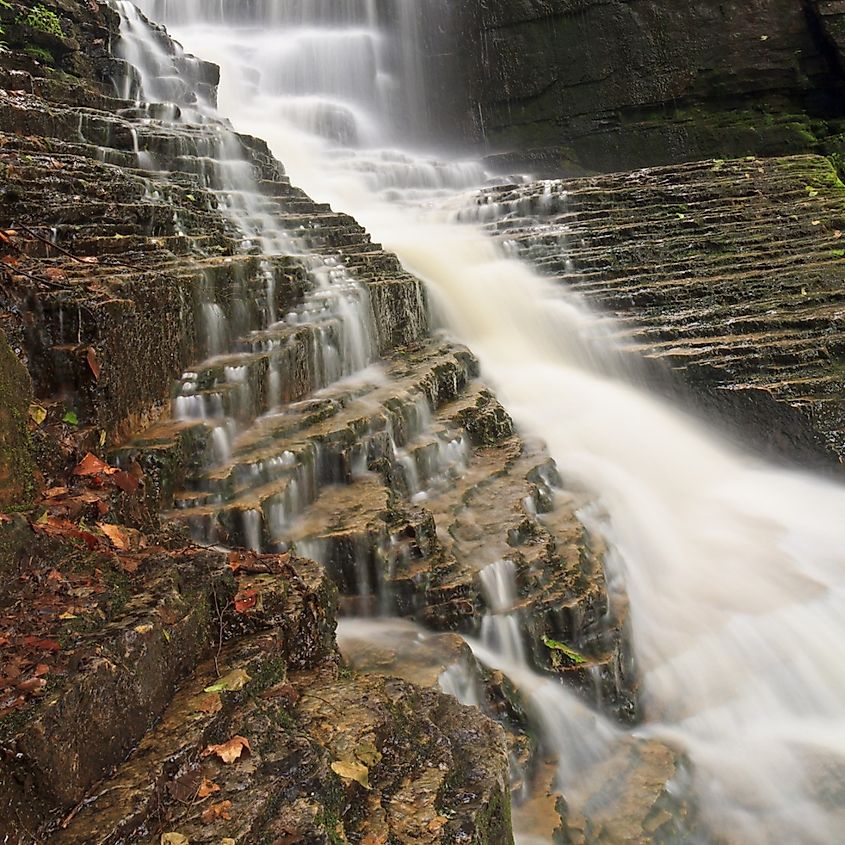 Water cascades over layers of rock and dead leaves at Lye Brook Falls near Manchester, Vermont, the tallest waterfall in Vermont.