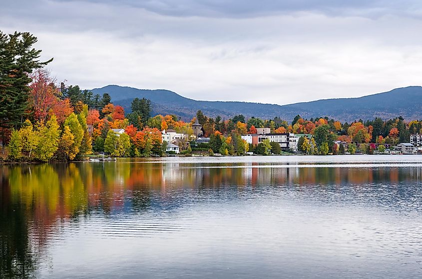 Buildings Among Colourful Trees on the The Shores of Mirror Lake in Lake Placid, NY, on a Cloudy Autumn Day.