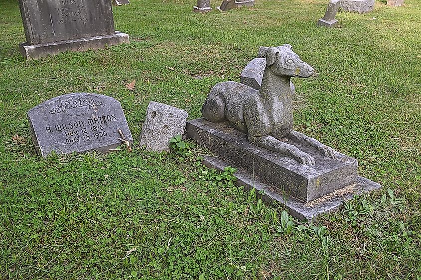 A concrete statue of a dog at Aspin Hill Memorial Park.