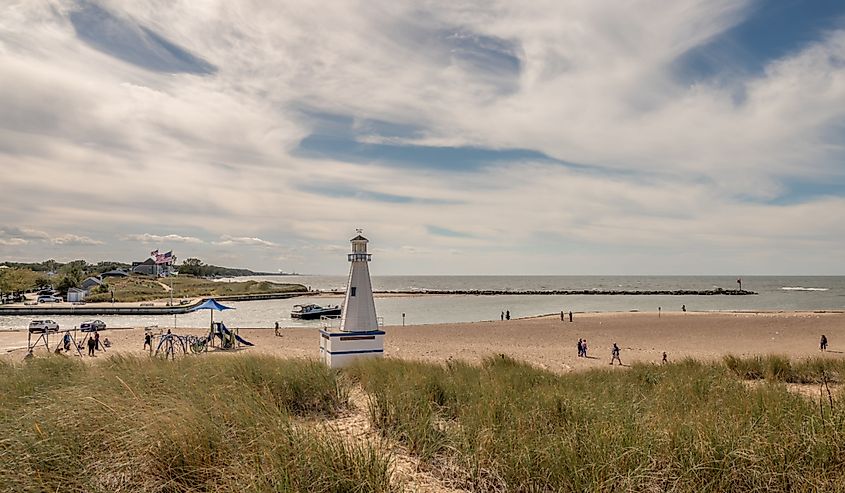 People explore the beach and harbor area in the town in summer, New Buffalo, Michigan. Image credit Page Light Studios via Shutterstock