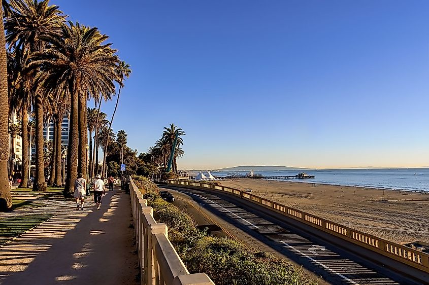 View of Santa Monica beach, California incline and Pacific Coast Highway and people walking in Palisades Park