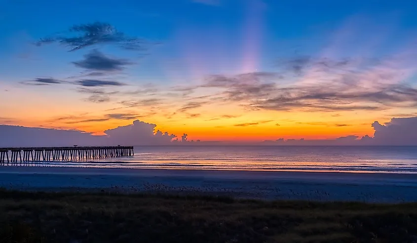 Sunrise over the Atlantic Ocean and the Jacksonville Beach pier in Jacksonville Beach Florida USA