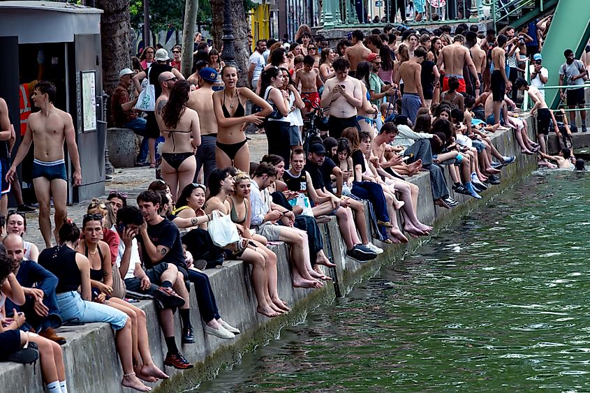 Parisians swim in the Saint Martin canal on a sweltering day. Editorial credit: Pierre Laborde / Shutterstock.com