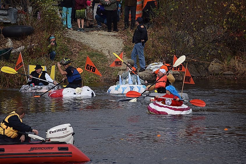 The participants are getting into their giant pumpkins to race in the 2014 Goffstown, NH Giant Pumpkin Regatta