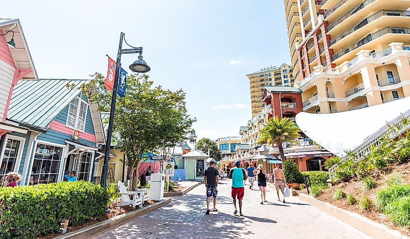 City town village Pirate's Alley on Harbor Boardwalk during sunny day in Florida panhandle gulf of mexico, tourists people walking