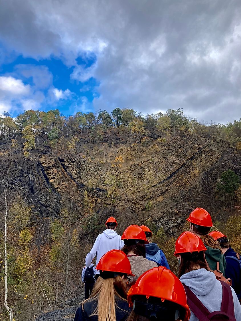 People hiking through an abandoned strip mine site near Centralia, Pennsylvania, observing tectonic plate activity.