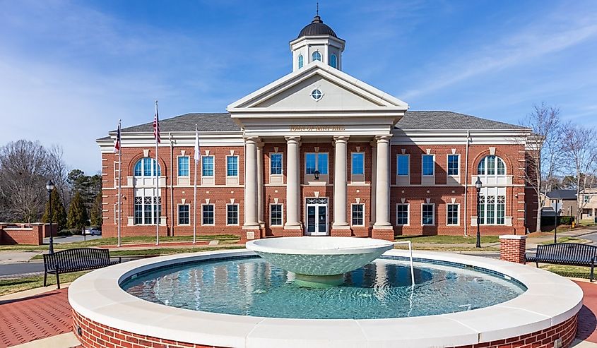 Mint Hill Town Hall, building with water feature in front. Sunny, blue sky day.