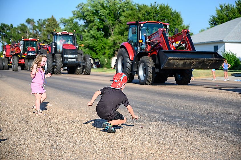 Children picking up candy at a County Fair Parade in Hoxie, Kansas.