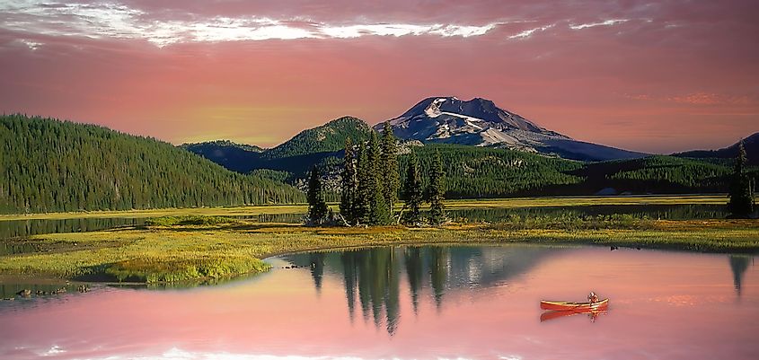 A woman in a red canoe on Sparks Lake, Oregon Cascade Mountains near Bend, via Bob Pool / Shutterstock.com