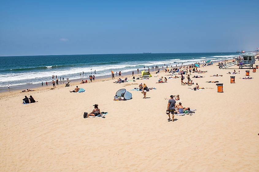 People enjoying the sun and ocean in Hermosa Beach, California