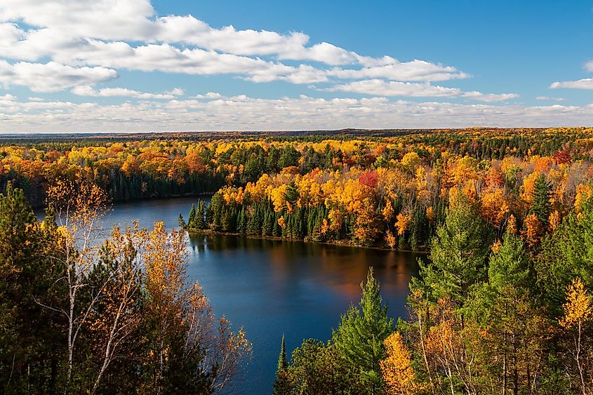 Sunny view of Highbanks overlooking Ausable River Cooke Dam Pond during autumn.