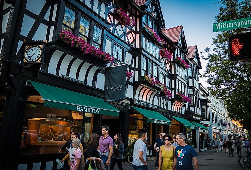 Shoppers and pedestrians near a Tudor-style building on Witherspoon Street in Princeton, New Jersey.