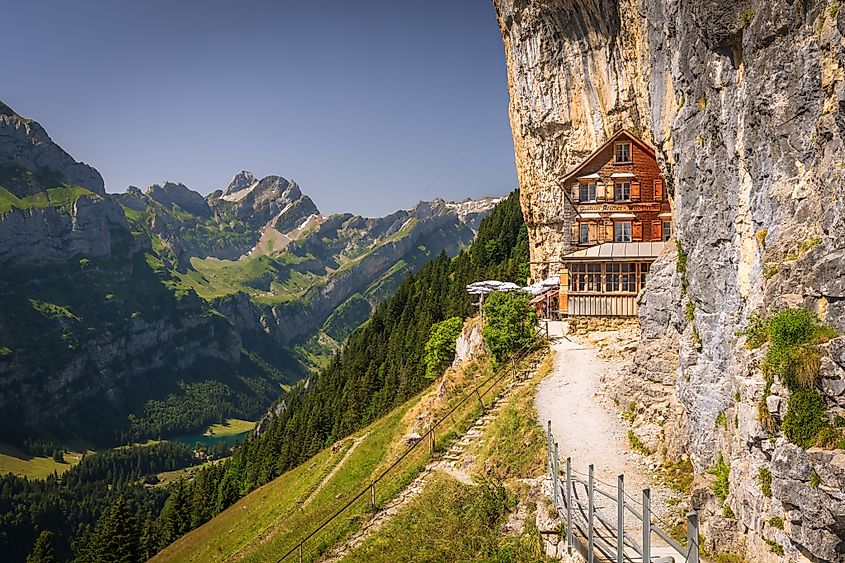 Berggasthaus Aescher in den Appenzeller Alpen, restaurant under a cliff on mountain Ebenalp in Switzerland, Appenzell.