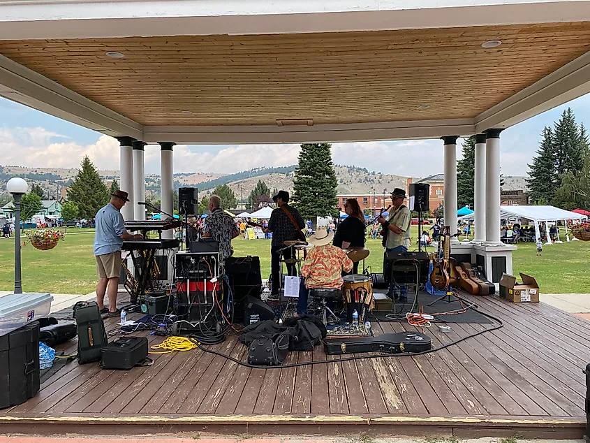 A country band plays out to a beautiful mountain park from a gazebo.