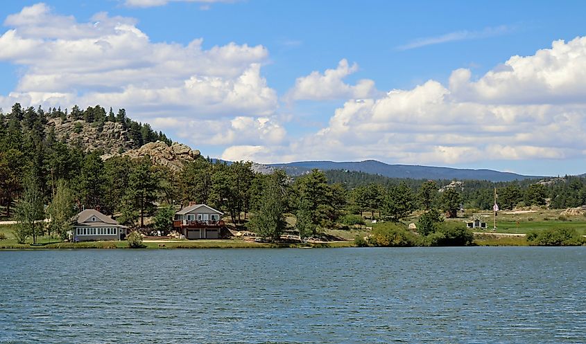 View of Ramona Lake in Red Feather Lakes, Colorado, with two dwellings near the shoreline