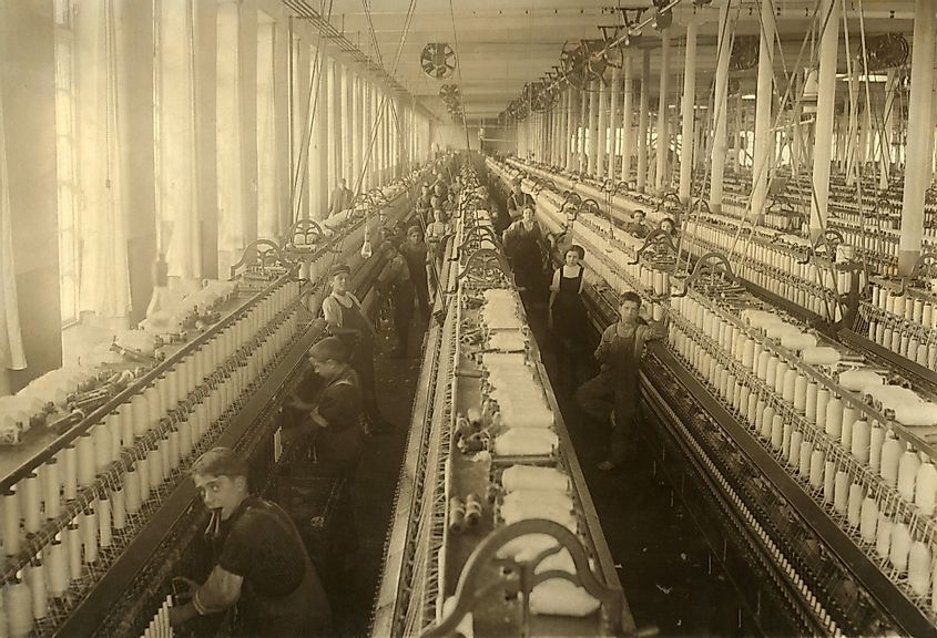 Young boys and girls working in the spinning room of the Cornell Mill in Fall River, Massachusetts.