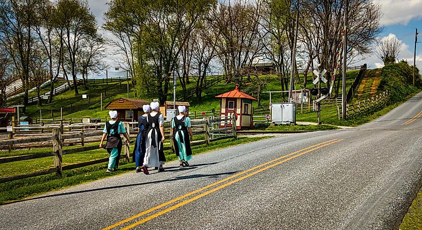 Amish teenagers walking along the rural countryside road in Lancaster County, Pennsylvania.