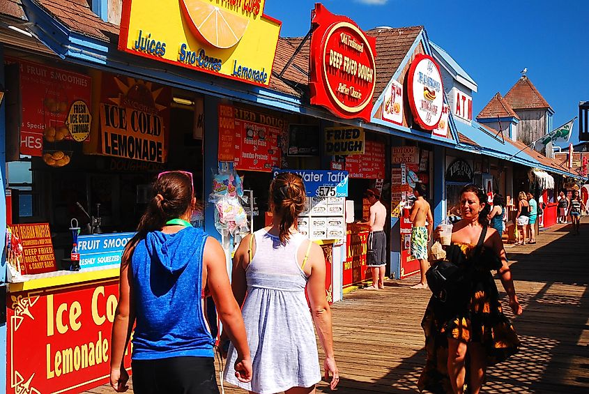 Young adults enjoy a sunny summer’s day on the pier in Old Orchard Beach, Maine, via James Kirkikis / Shutterstock.com