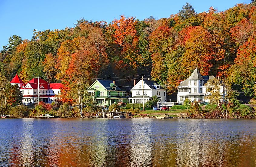 View of Saranac Lake, New York in the Adirondack Mountains during fall. 