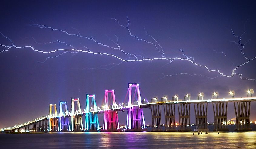 Bridge over the lake of maracaibo at night with colorful lights and lightening
