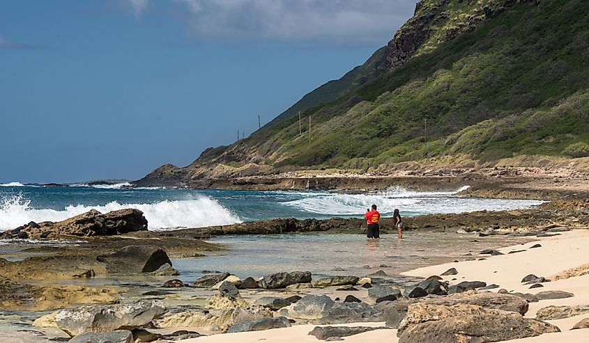 Locals in rock pool at Ka'ena Point along the west coast of Oahu, Hawaii