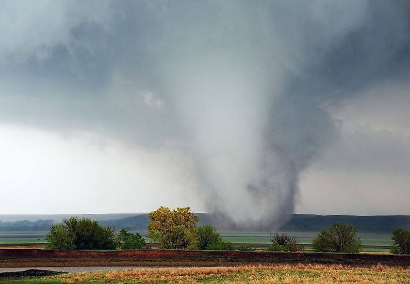 A white cone tornado moves across Kansas field near Salina, Kansas