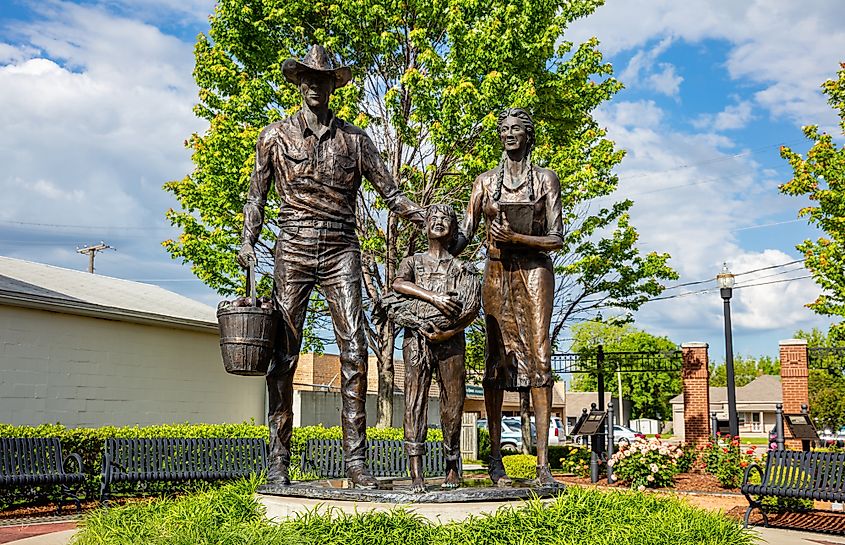 Bronze statue of an early 20th-century agriculture family, at Centennial Park on Main Street.