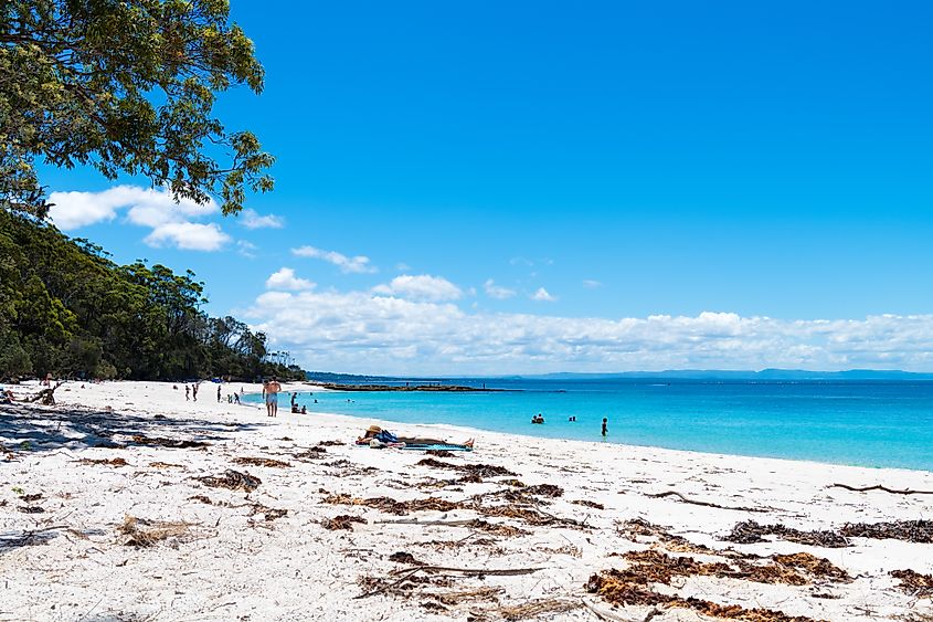 People enjoying the sunny weather at the tranquil, white-sand Murrays Beach in Jervis Bay, Booderee National Park, NSW. 