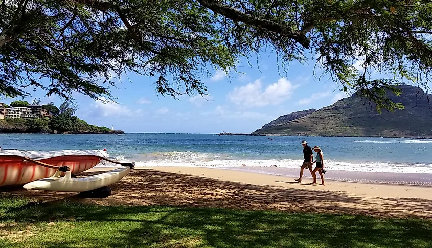 A couple walks along Kalapaki Beach in Lihue, Kaua’i, Hawai’i