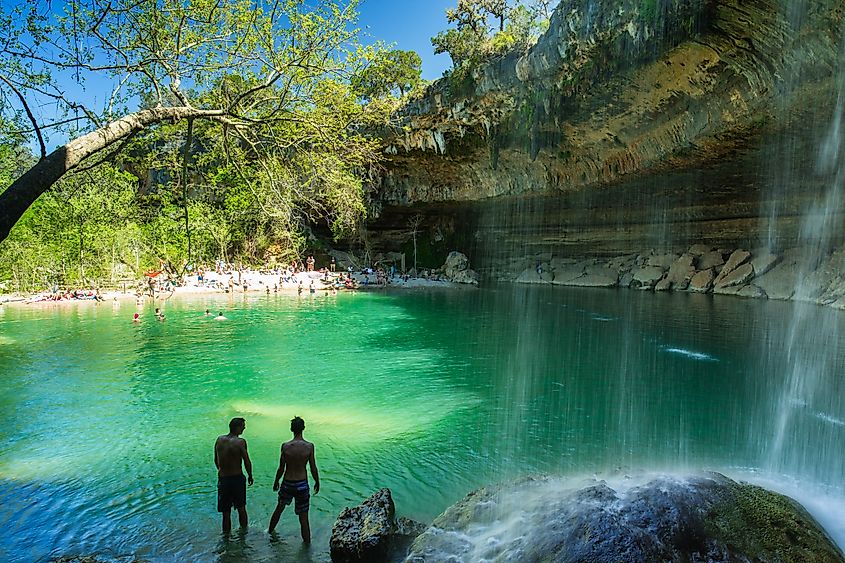 Visitors swimming in the Hamilton Pool.