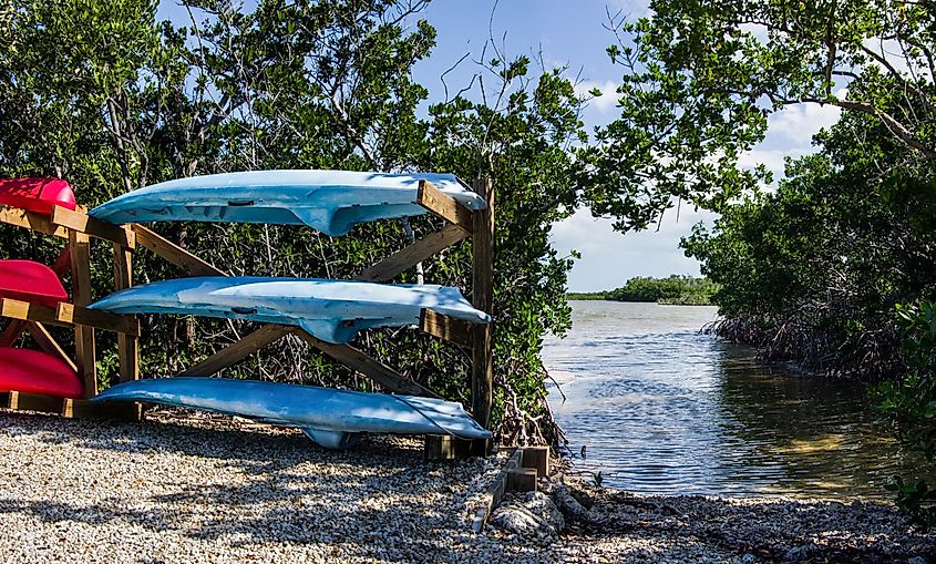 Rental canoes and kayaks wait beside a launch area in Long Key State Park.