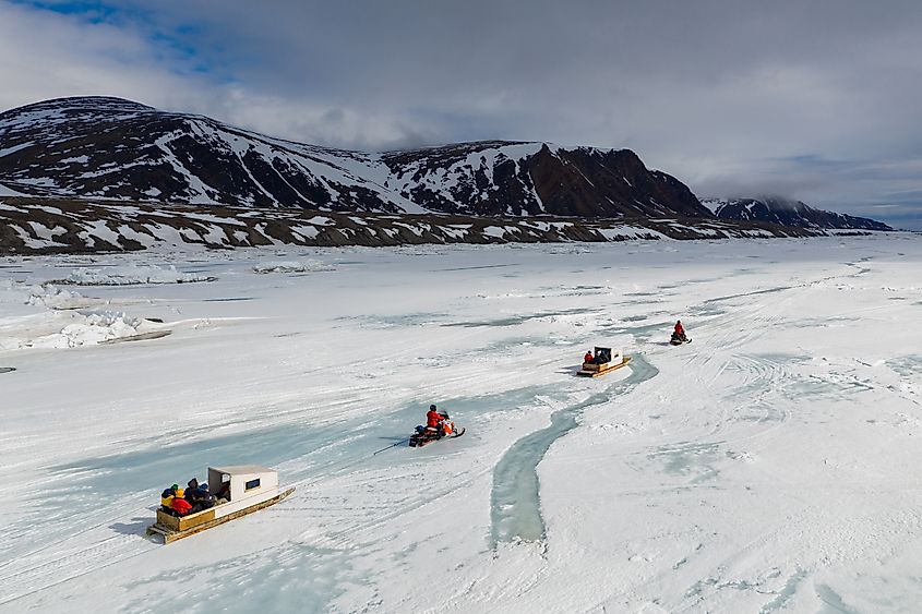 Tourists travelling by Qamutiik on the sea ice near Sirmilik National Park in Nunavut, Canada