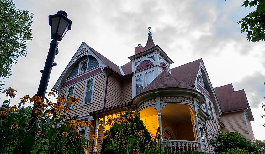 The Scandinavian Inn, a Victorian style Bed and Breakfast after sunset and flowers in garden, at dusk.