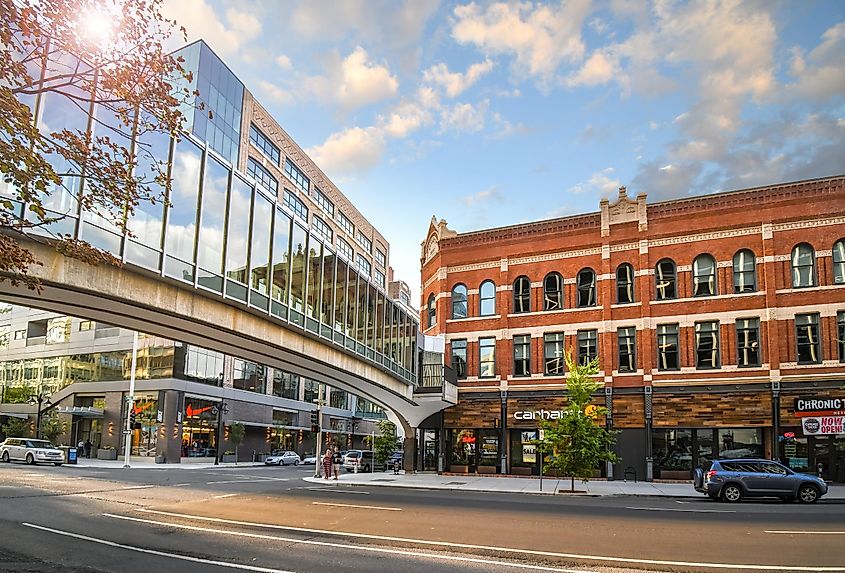 Pedestrians cross the street under the enclosed pedestrian bridge near the Bennett Building in the downtown district of Spokane, Washington, via Kirk Fisher / Shutterstock.com