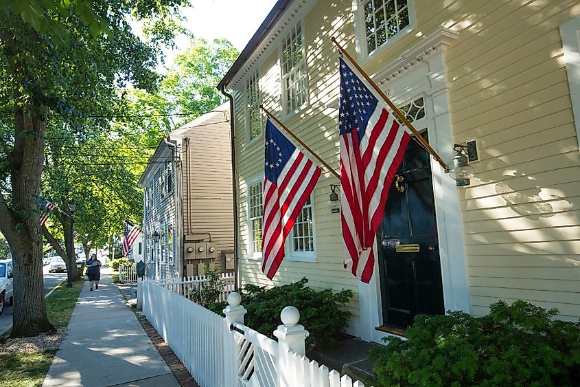 American flags and a white picket fence line Main Street in Essex, an all-American village.