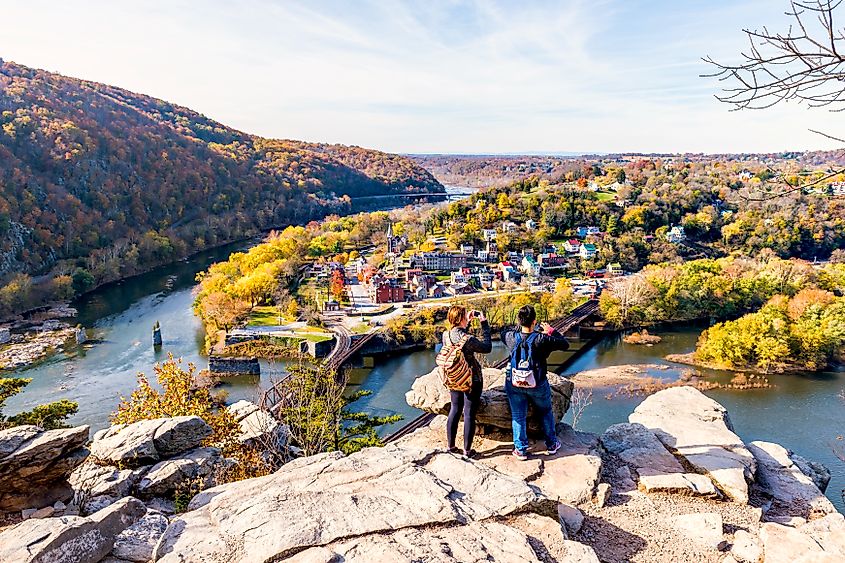 Hikers photographing Harpers Ferry from a clifftop. Editorial credit: Andriy Blokhin / Shutterstock.com